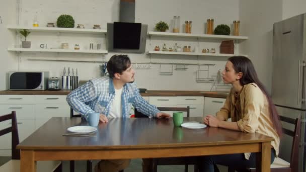 Muž na ženu sedící v domácí kuchyni — Stock video