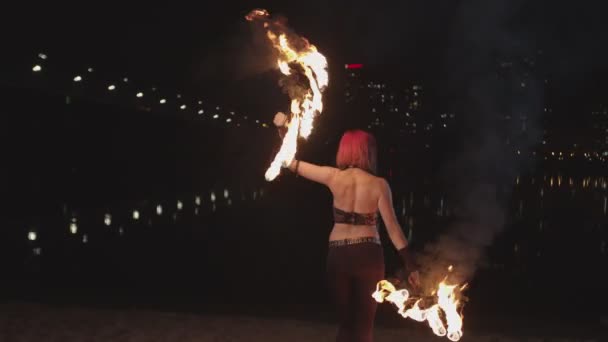 Woman performing dance with flaming fans at dusk — Stock Video