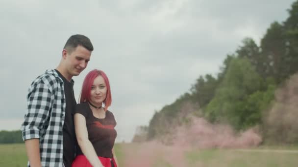 Portrait of couple with color smoke bomb outdoors — Stock Video