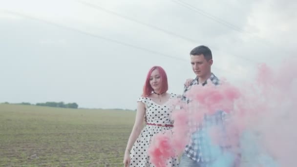 Lovely couple making colored smoke heart outdoors — Stock Video