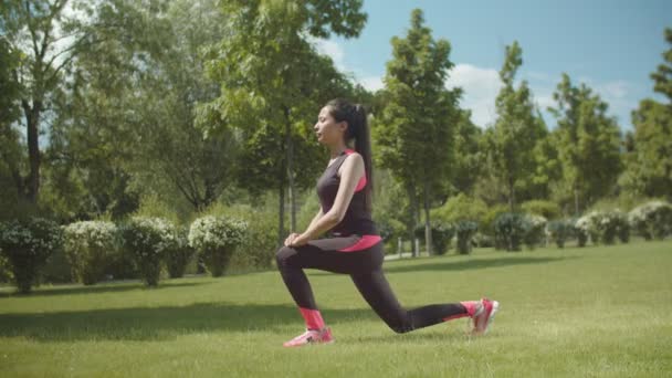 Fitness vrouw doet longe oefening op Park gazon — Stockvideo