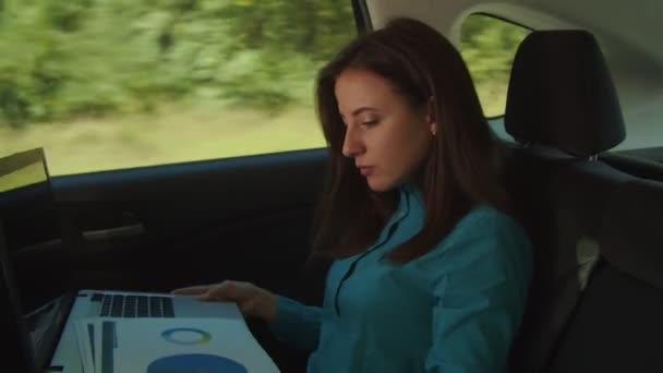 Female entrepreneur working with documents in car — Stock Video