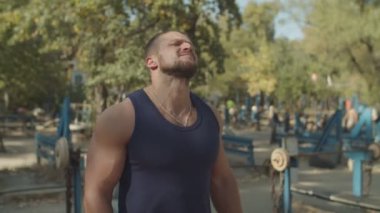 Güçlü atlet açık spor salonunda kaslarını esneme