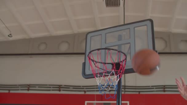 Black basketball player performing alley oop dunk — Stock video