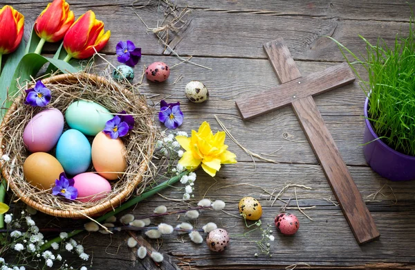Easter Colorful Eggs Nest Flowers Vintage Wooden Boards Cross — Stock Photo, Image