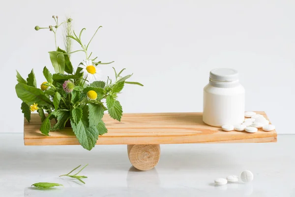 Alternative medicine or pills weight balance comparison with tablets and herbs