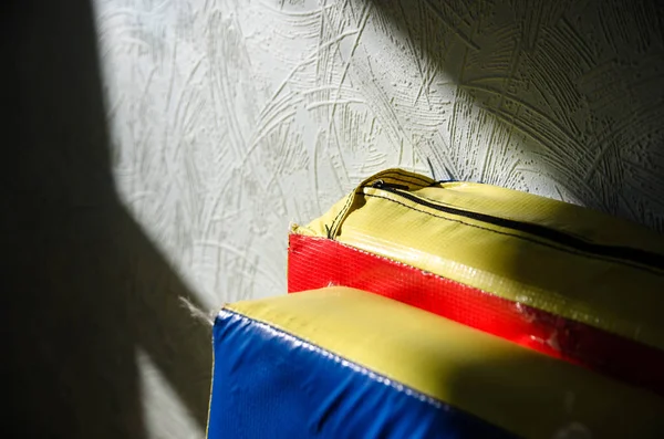 sports mats for martial arts leaning against a wall