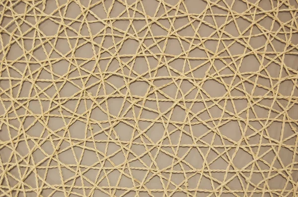 woven mesh of artificial material on beige background