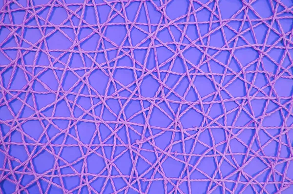 woven mesh of artificial material on a violet background