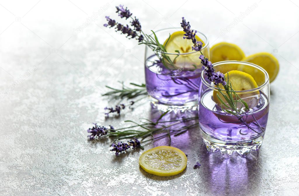Fresh drink with lemon and lavender flowers. Cold summer lemonade