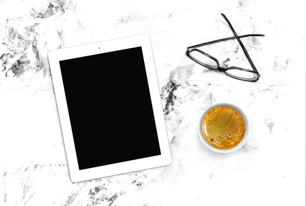 Tablet pc, coffee and glasses. Minimal flat lay