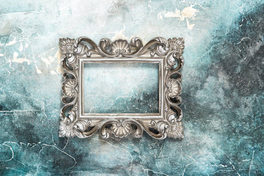 Vintage silver baroque style picture frame on stone background 