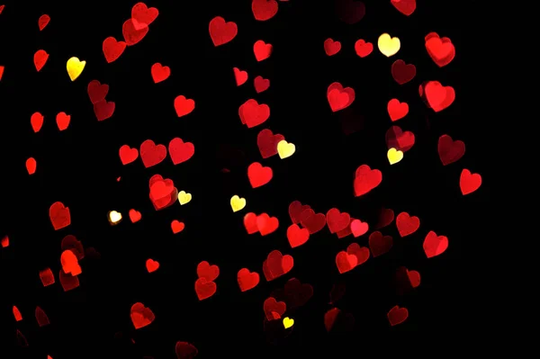Defocused bokeh lights heart decoration. Abstract shiny love background