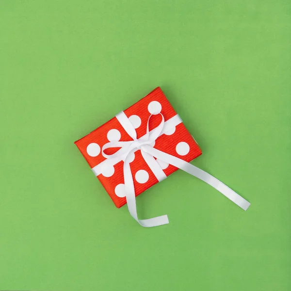 Gift box red white on green background. Voucher gift card concept