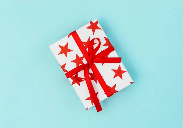 Gift box red stars on blue background. Voucher gift card concept