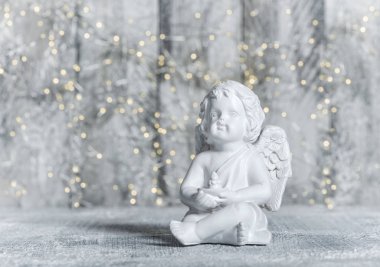 Küçük melek Festival ışık arka plan ile. Noel dekorasyon