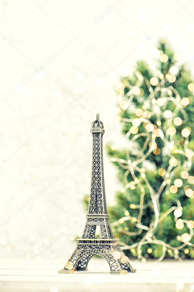 Eiffel Tower with Christmas tree decoration golden lights. Paris France. Vintage toned photo