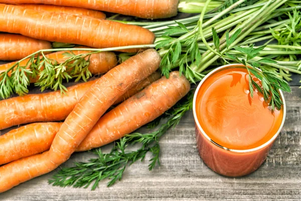 Carrot juice with fresh raw vegetable roots. Healthy food and drinks