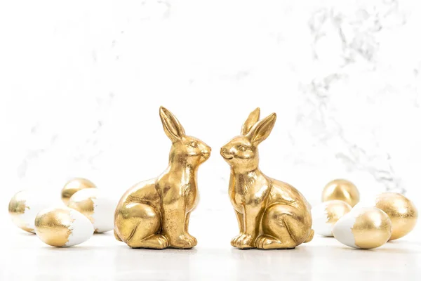 Golden rabbits Easter eggs white background — Stock Photo, Image