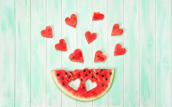 Watermelon hearts wooden background Creative summer food — Stock Photo, Image