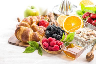Sağlıklı yiyecekler. Taze böğürtlenli kahvaltı masası, meyve, bal, kruvasan, müsli