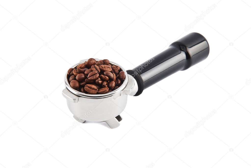 Portafilter filled with whole coffee beans isolated on white background. Filter holder for espresso coffee machine. Black Espresso handle.