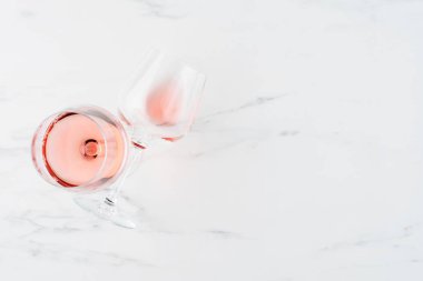 Summer drink. Glass of rose wine on white marble background with copy space for text. Top view. Horizontal.
