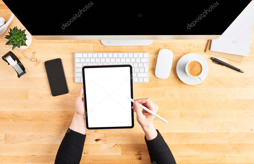 Female hands working on digital tablet with pencil