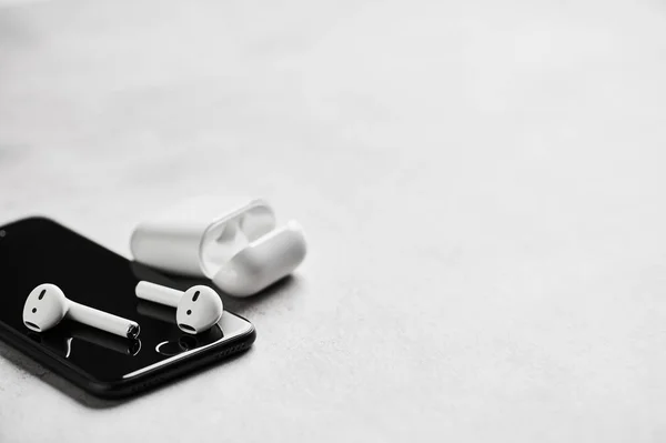 Бездротові навушники з футляром та смартфоном . — стокове фото