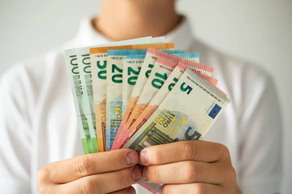 Hand holding euro banknotes. Selective focus. Man holds banknotes