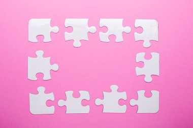 Pembe arka planda beyaz bulmaca. Kayıp parça. Üst görünüm