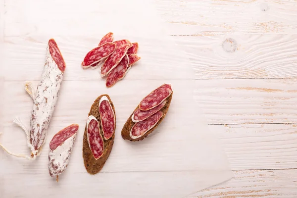 Salami Bread White Wooden Background Top View Copy Space — Stock Photo, Image