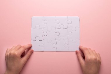 Son el yapboz parçası. İş kavramı başarısı. Pembe bir arka plan. Üstten görünüm.