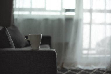Bir fincan kahve. Gri kanepe. Büyük pencere. İskandinav tarzı. Kopya alanı