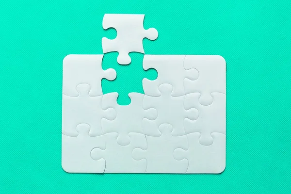 Jigsaw Puzzle with missing piece on mint background Top view