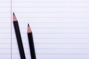 Satır beyaz levha üzerinde iki siyah grafit kalem geri okula, eğitim kavramı için alan kopyalayın