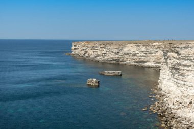 Güneşli bir günde mavi denizin kayalık kıyılarının güzel manzarası.