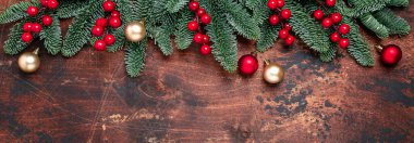 Noel arkaplanı köknar ağacı dalları, Holly ve Noel topları ahşap masada. Yatay pankart. Uzayı kopyala - Resim