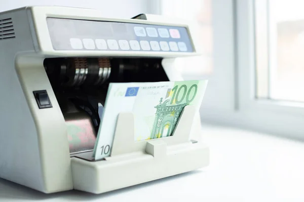Electronic money counter machine is counting the euro banknotes. Automatic money counting in the machine - Image