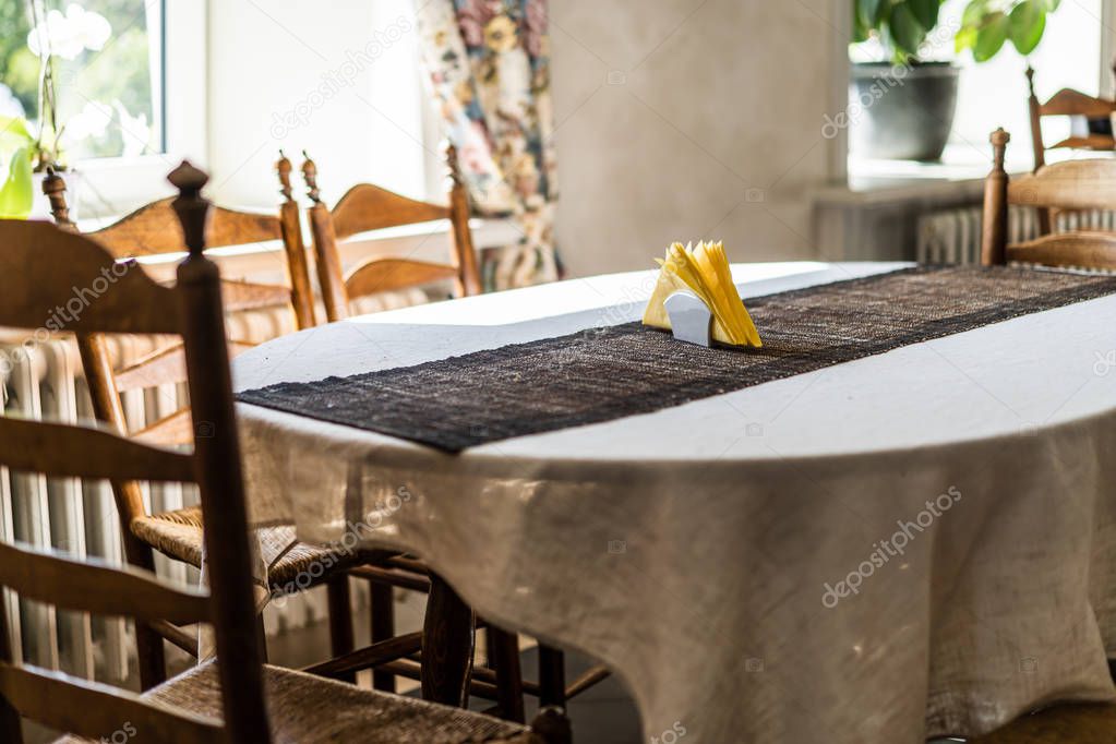 Empty Restaurant Table in Hotel with Yellow Napkins on it - Window Seat with Bright Light