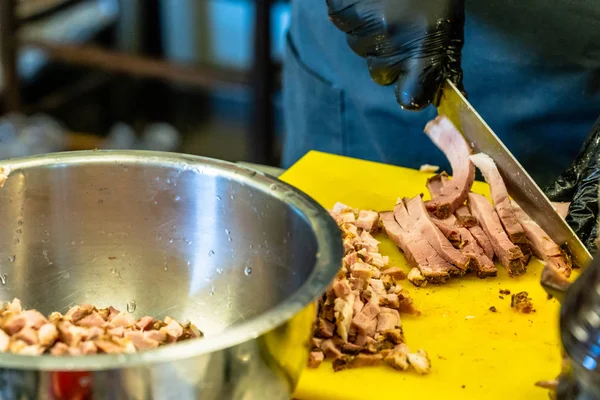 Cutted Ham Yello Cutting Board Blurred Chef Hands Background — стоковое фото