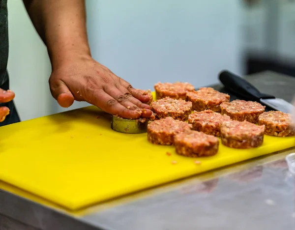 Male Chef Making Round Pork Cutlet for Some Burgers for  Wedding Meal - Kitchen Set, Isolated Action with Chef`s Hands