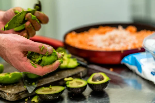 Male Chef Pealing Avocado for  Wedding Meal - Kitchen Set with Isolated Action, Only Chef`s Hands