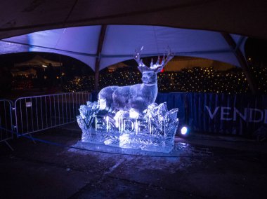 Jelgava / Latvia - February 10th, 2017: White lighted deer ice sculpture at night of International Ice Sculpture Festival in Jelgava. clipart
