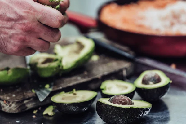 Male Chef Pealing Avocado for Wedding Meal - Kitchen Set with Isolated Action, Only Chef`s Hands, Vintage Film Look