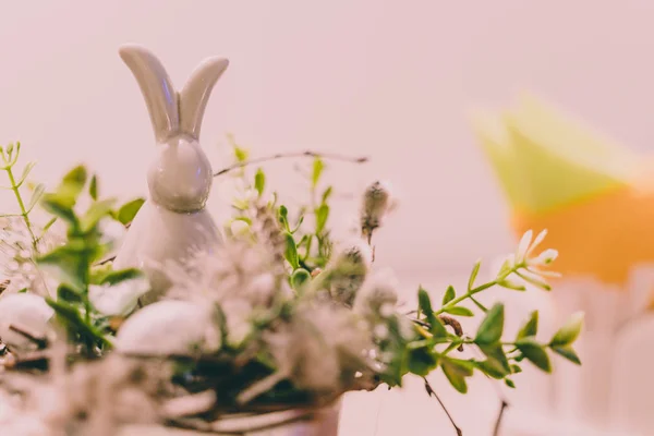 Isolated Handmade Easter Decorations (Bunny with Blossom Flowers in a Bucket on Table with Napkins Beside) - Concept of the Harmony and Peace in Family