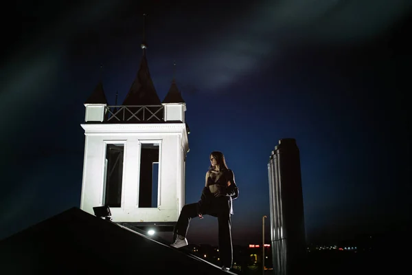 Sexy girl in the suit on the roof