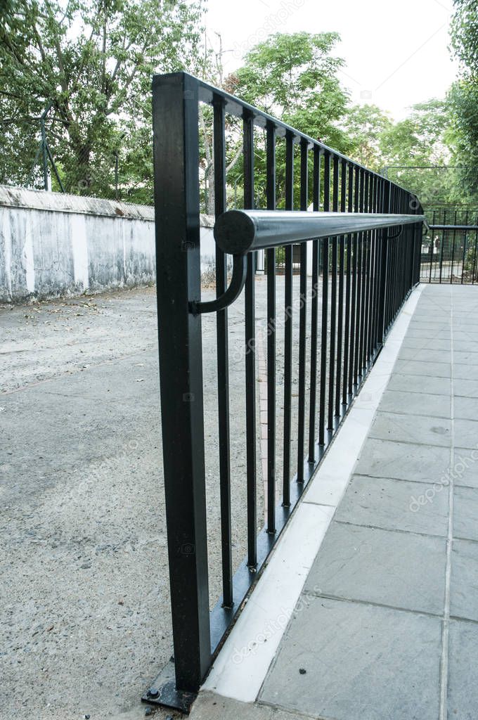 Protection railing for access ramp to a building in black color