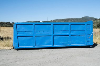 Truck haul truck in blue color resting on the ground clipart
