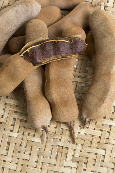 Tamarind, a natural fruit from tropical Africa and appreciated in the cuisine and herbal medicine of the whole world, on wicker basket